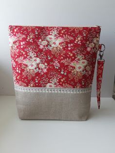 a red and white bag with flowers on it