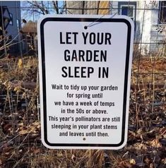 a sign that is posted in the grass