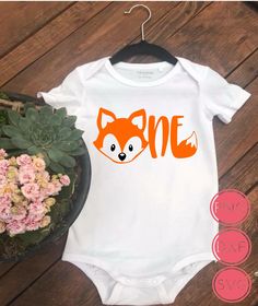 a baby bodysuit with an orange fox on it