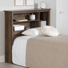 a bed with a book shelf next to it