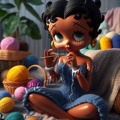 a doll sitting on top of a bed next to balls of yarn and knitting needles