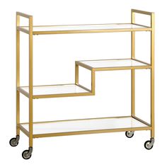 a gold metal and glass shelf on wheels