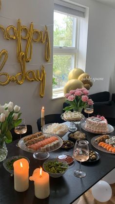 a table topped with lots of food and candles