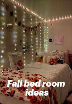 a bed room with a neatly made bed and lights on the wall above it that reads, fall bed room ideas