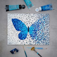 the blue butterfly is being used to make this mosaic art project with acrylic paint