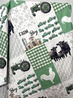 a green and white quilted shirt with farm animals, tractors and trucks on it