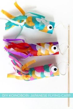 three fish shaped lollipop sticks on a white background with the words diy koinobori japanese flying carps