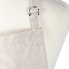 a close up of a white piece of cloth with a metal ring on the end