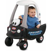 a young boy riding in a black and white toy car with panda face on it