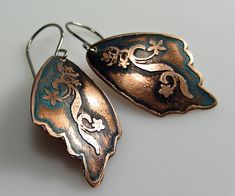 I produce designs by hand or digitally and transfer these onto metal using modern etching techniques. I seal each piece with a clear, protective coat in a satin finish. Hand etched wings earrings with Wax Patina. Total length including ear wires is approx 2 x 1inch or 50 x 25mm. All jewelry is handcrafted in my studio. Item ships registered mail. All my items are safely and nicely packed in solid gift boxes, ready for gift giving! Enter my shop here: https://www.etsy.com/shop/DrahomiraJewelry?re Stamped Metal Earrings For Gifts, Gift Copper Etched Earrings, Bronze Etched Earrings For Gift, Artistic Etched Earrings As A Gift, Metal Animals, Etched Jewelry, Hammered Copper Earrings, Wings Earrings, Copper Anniversary Gifts