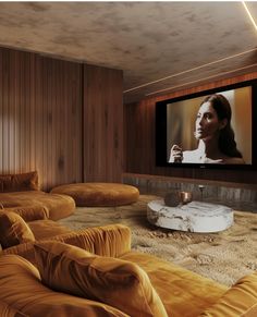 a living room with yellow couches and a flat screen tv mounted on the wall