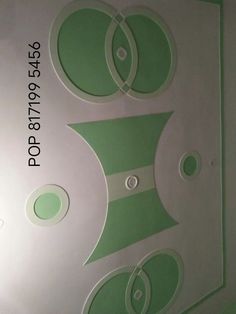 the back side of a white and green wallpaper with circles on it's sides