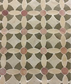 a close up view of a mosaic tile design with circles and leaves on it's surface