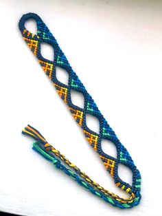 two bracelets with different colors and designs on the ends, one is made out of string