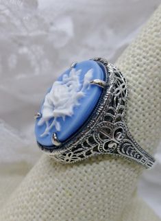 <> Design #230 This is a brand new stunning Art Nouveau/Vintage designed sterling silver filigree blue cameo ring. The Flawless oval cut high-quality cameo is 18mm (just shy of 3/4th of an inch) by 13mm (1/2 inch) in dimension... This ring is 21mm NS on the finger. The inside of the band is marked 925 for sterling. Notice the beautiful filigree swirl like the craftsmanship of the silver setting. This lovely ring stands out and illuminates the finger with its great shine. This is an exquisi Lady Silhouette, Dark Garnet, Flower Lady, Art Deco Flower, Butterfly Vintage, Cameo Ring, Deco Vintage, Art Deco Wedding, Sterling Silver Filigree