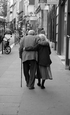 an old couple walking down the street with a quote about falling in love is easy but staying in love is very special