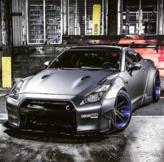 a silver sports car parked in front of a building