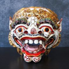 an elaborate mask is displayed on a table