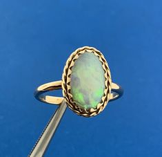 * Vintage 14K Yellow Gold Oval Opal Cabochon Solitaire October Anniversary Ring * Ring size: 8.0 * Top of ring measures: 3/4" x 1/2" * Height: 1/8" * Band width: 2.06 mm or approximately 1/16" * Oval Opal Cabochon measures approximately 14.0 mm x 8.5 mm * Ring weight: 3.1 tgw * Marked: MAKERS MARK * 14K * Condition: As pictured. * G2967 5% Restocking Fee    Exported By ExportYourStore :) Anniversary Ring, Ring Ring, Womens Jewelry Rings, Rings Statement, Anniversary Rings, Makers Mark, Favorite Jewelry, Statement Rings, Vintage Jewelry