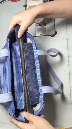 someone is opening the inside of a blue bag