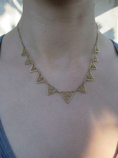 "Say hello to this beautifully made antique 18k yellow gold draperie necklace. This one has just the right amount of bold and delicate. Crafted in 18k solid gold, graduated triangles with pretty heart detailing make up the center piece of the necklace with gorgeous bar links to finish it off. Wear along or dare to stack with other necklaces in your collection! Very good vintage condition. The spring clasp may be a replacement; accounted for in the price. 17.0\" in length Largest triangle measure Ruby Heart Ring, 1920s Necklace, Ruby Heart, Pretty Heart, South Pasadena, Gold Link Chain, Gold Filigree, Chain Link Necklace, Silver Diamonds