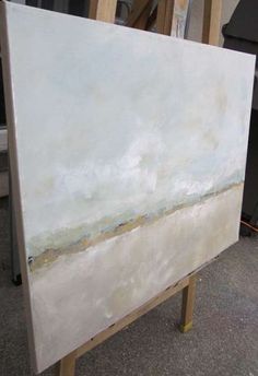 an easel with a painting on it in the process of being painted