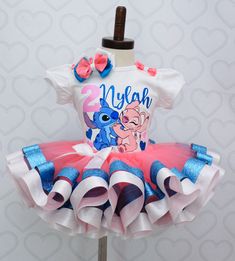 a pink and blue tutu skirted dress with an elephant on it