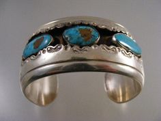 "Lovely vintage Signed Native American Turquoise Shadowbox Cuff Bracelet in Sterling Silver. Bracelet 1.29\" (32.9mm) wide. Turquoise stones measure 10x19mm, 12x16mm, and 9.5x20mm. Interior of bracelet measures 5 1/8\", with an additional 1 1/8\" opening gap, for a total of 6 1/4\". This cuff is not sizable. Bracelet has a nice weight of 67.5 grams. Signed GD as can be seen in photo #5. Tests positive for sterling. In very good pre-owned condition." Turquoise Stamped Cuff Bracelet Collectible, Antique Turquoise Bangle Cuff Bracelet, Vintage Turquoise Bracelets As Gift, Stamped Turquoise Bracelet As Gift, Vintage Turquoise Bangle Cuff Bracelet, Blue Vintage Stamped Jewelry, Antique Stamped Turquoise Jewelry, Vintage Stamped Blue Jewelry, Antique Turquoise Bangle