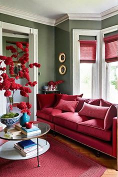 a living room filled with red furniture and flowers