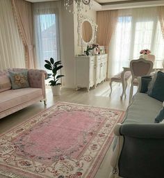 a living room filled with furniture and a pink rug