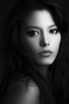 a black and white photo of a woman with long hair