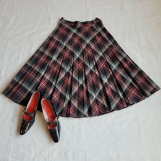 "Brand: unknown  Size: 26\" waist; see measurements  Color: black/red Fabric Content: wool   Features: Cut on the bias this skirt sports a smart black and red plaid with alternating pleating. This shape of this piece is done in an A-line so it is great for most body types. The closure is your traditional zipper/button combo on the left side.    Measurements: Waist: 26in  Hip: 34in  Center Back Length: 28in    Condition: Very good    Care: Dry clean only  Vintage sizing varies. Please check your Fitted Accordion Pleats Skirt For Fall, Classic Plaid Skirt For Fall, Fall Fitted Full Pleated Skirt, Fitted Full Pleated Skirt For Fall, Fitted Full Skirt In Plaid, Red Fitted Pleated Skirt For Fall, Fitted Accordion Pleat Skirt For Winter, Fitted Red Pleated Skirt For Fall, Fitted Red Pleated Skirt For Winter