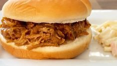 a pulled pork sandwich with cole slaw on the side