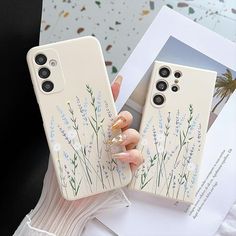 two phone cases with flowers painted on them, one is holding a wine glass in the other hand