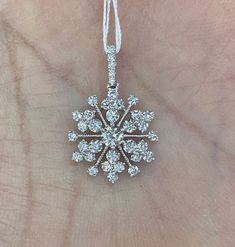 "Diamond Snowflake Pendant set with beautiful clear and sparkling diamonds. Excellent craftsmanship, lays nicely on the neck won't flip around. Give the gift of good luck with this pretty necklace. The diamonds are clean and of good quality; this is one she will treasure for a lifetime. Measures about 23mm length by 15mm width. Available 16\" strong 14K white gold link chain for purchase. Genuine Round Brilliant Cut Diamonds total weight: 1.06 carats Clarity: VS/SI Color: G 18K White gold Comes Diamond White Snowflake Jewelry For Anniversary, Diamond White Snowflake Jewelry For Formal Occasions, Formal Snowflake Diamond White Jewelry, Diamond White Cubic Zirconia Snowflake Jewelry, White Gold Diamond Snowflake Jewelry, Sparkling Diamond Pendant Necklace, Formal Diamond Snowflake Jewelry, Formal Snowflake Diamond Jewelry, White Snowflake Fine Jewelry