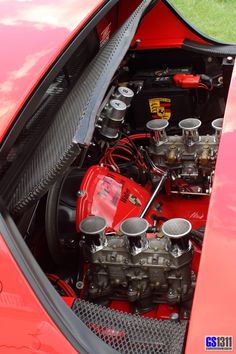 the engine compartment of a red sports car