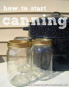 two mason jars sitting on top of a table next to a pot and the words canning