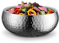 a large metal bowl filled with lots of salad