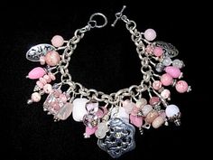 Here's a vesatile piece!  A 7 inch charm bracelet composed with Rhodochrosite, Pink Quartz, Pink Jade, Peruvian Opal,Crystals, and Designer Glass infused with pink.  Plus there are 5 Sterling Silver Charms spaced within for accent and the clasp is also Sterling silver.  The bracelet itself is made from Thai Silver link chain, which has a higher content of pure silver compared to Sterling.   For a new look, this bracelet can be attached to the 10 1/2 inch Rhodium large link chain and turned into Elegant Pink Dangle Charm Bracelet, Elegant Pink Bracelets With Dangling Charms, Designer Glass, Pink Jade, Silver Link Chain, Quartz Pink, Sterling Silver Charms, Peruvian Opal, Pink Necklace