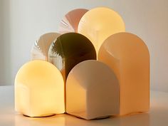 an assortment of different shapes and sizes of lights on a table with a white wall in the background