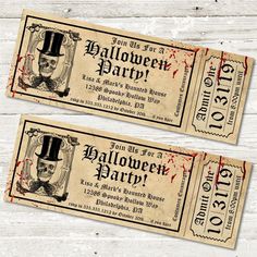 two halloween party tickets sitting on top of a wooden table