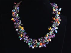 This striking, vibrant multi-color 24" necklace was hand beaded by one of our group of Mayan women in the village of Santiago Atitlan, Guatemala. Twisted strands of beads and natural stones create a stunning and unique look. The strands can be twisted tighter for an even more dramatic look. Each necklace is individually handmade; therefore there may be a slight variance in the placement and color of the natural stones and beads 24" tip to tip Toggle closure with 3 adjustment loops Multicolored C Multicolor Czech Glass Beads For Party, Multicolor Crystal Necklaces With Colorful Beads For Party, Whimsical Beaded Necklaces For Party, Party Crystal Necklaces With Colorful Beads, Whimsical Party Beaded Necklaces, Multicolor Gemstone Beads For Party, Whimsical Multicolor Jewelry With Large Beads, Multicolor Czech Glass Beaded Necklace For Parties, Party Multicolor Czech Glass Beaded Necklaces