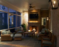 a living room filled with furniture and a fire place in front of a tv mounted on the wall