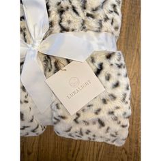 the leopard print blanket has a white ribbon on it