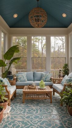 a sun room with couches, tables and potted plants