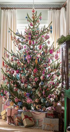 a decorated christmas tree with presents under it