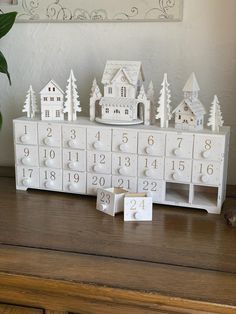 a wooden calendar sitting on top of a table next to a vase filled with flowers