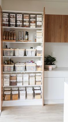 an organized pantry with lots of containers and food on the shelves in front of it