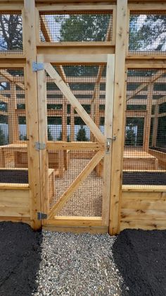 a wooden fenced in area with an open gate