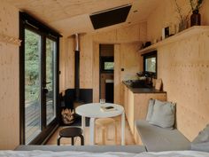 the interior of a tiny cabin with wood paneling